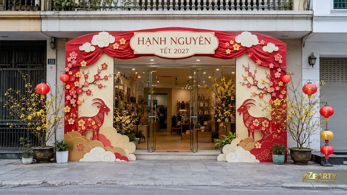 Mặt tiền Hạnh Nguyên với khung cổng đỏ kem, đôi dê, mây cách điệu và hoa mai