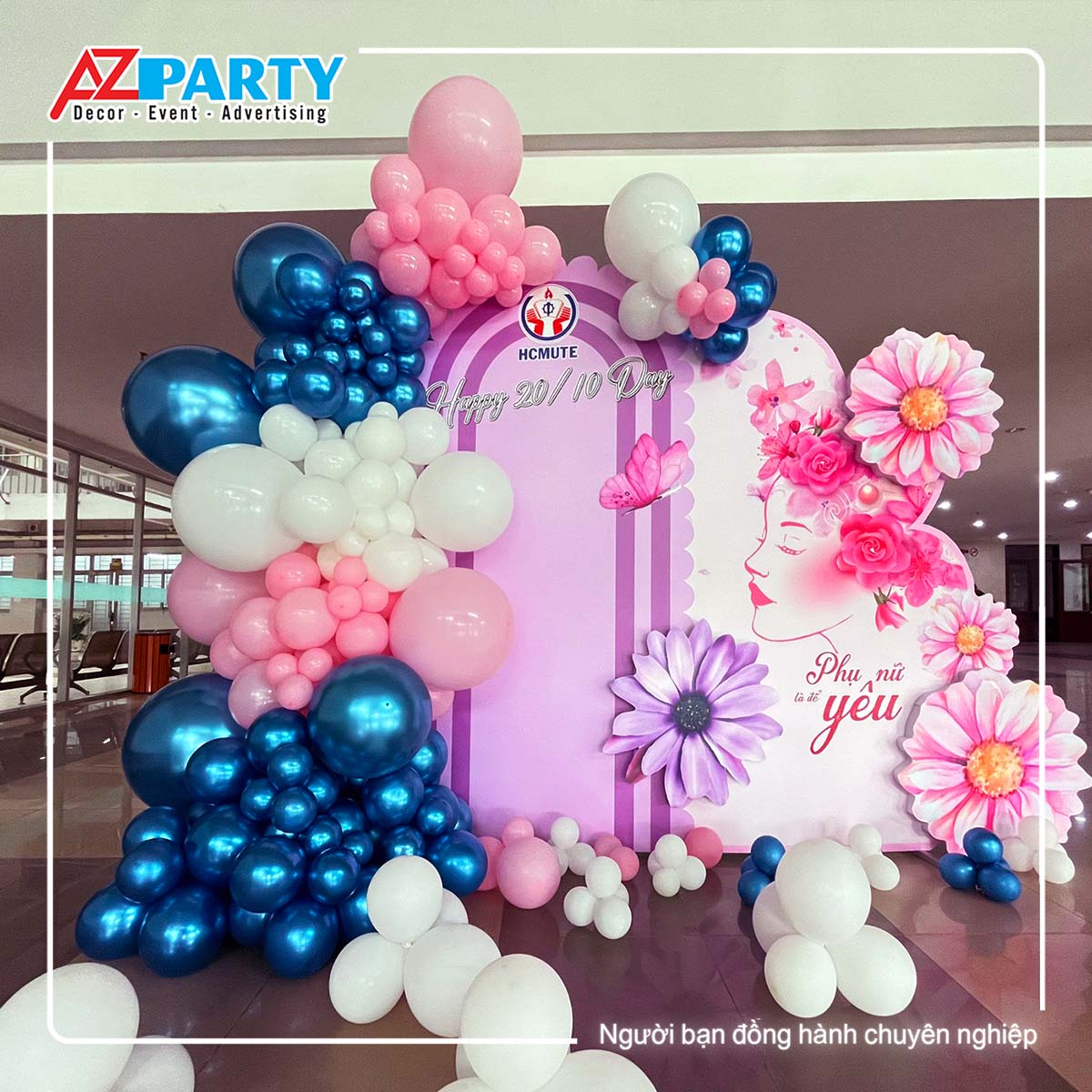 backdrop phụ nữ Việt nam với tone màu tím, hồng xanh đậm. Điểm nhấn là các hình bông hoa nổi khối