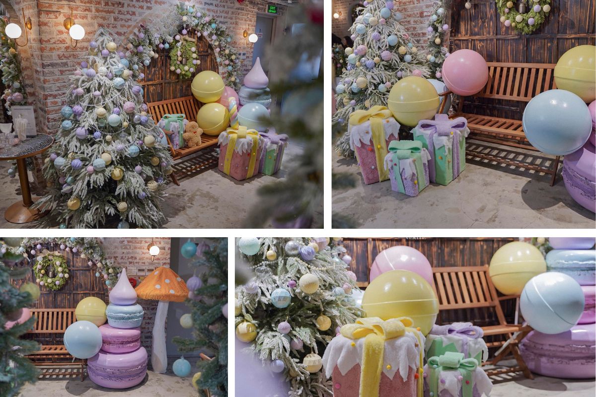 Góc trang trí Giáng sinh trong quán cà phê với cây thông phủ tuyết, những hộp quà màu pastel và viên kẹo tròn khổng lồ tạo cảm giác ngọt ngào, ấm áp.