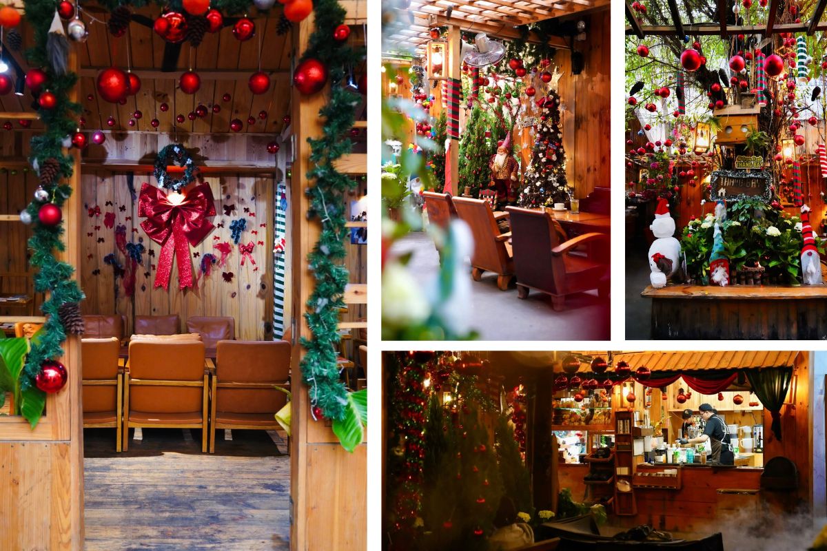 Không gian quán cà phê ấm áp với tường gỗ, cây thông Noel, vòng hoa xanh và nơ đỏ nổi bật. Khu vực bàn ghế được trang trí đèn treo, quả châu và tượng ông già Noel, mang lại cảm giác gần gũi, rực rỡ và đậm chất Giáng sinh truyền thống.