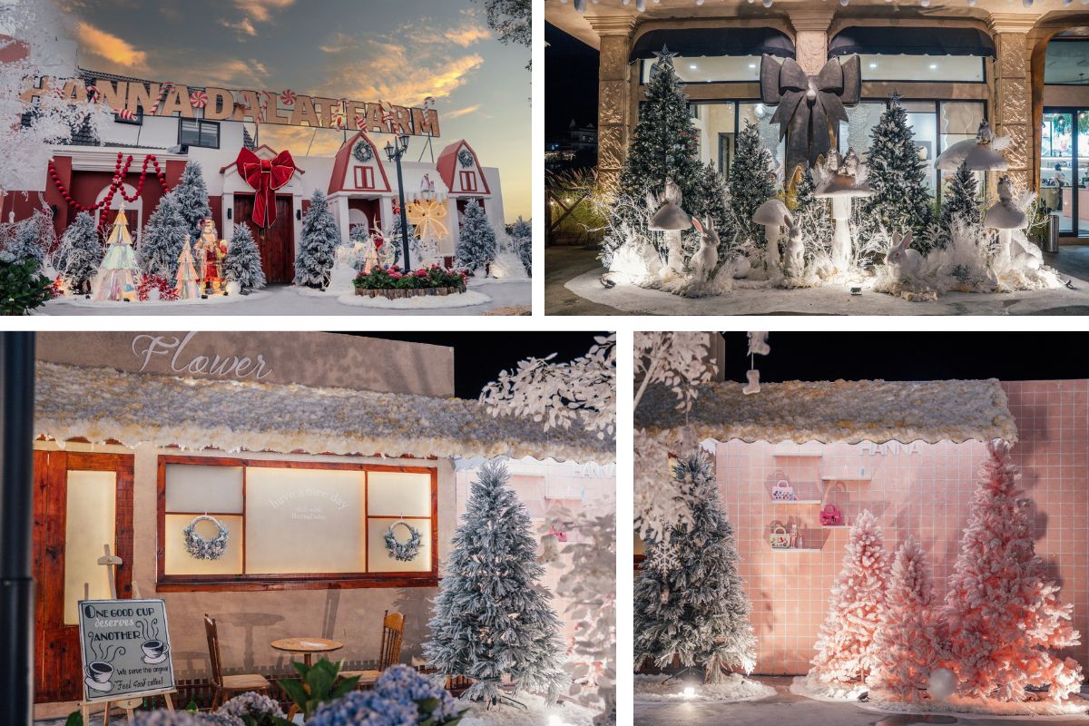 Khu trang trí Giáng sinh ngoài trời với những ngôi nhà nhỏ phủ tuyết, cây thông trắng và ánh đèn vàng ấm áp. Không gian kết hợp giữa sắc đỏ, hồng và xanh pastel tạo cảm giác ngọt ngào, dễ thương và mang đậm tinh thần lễ hội.