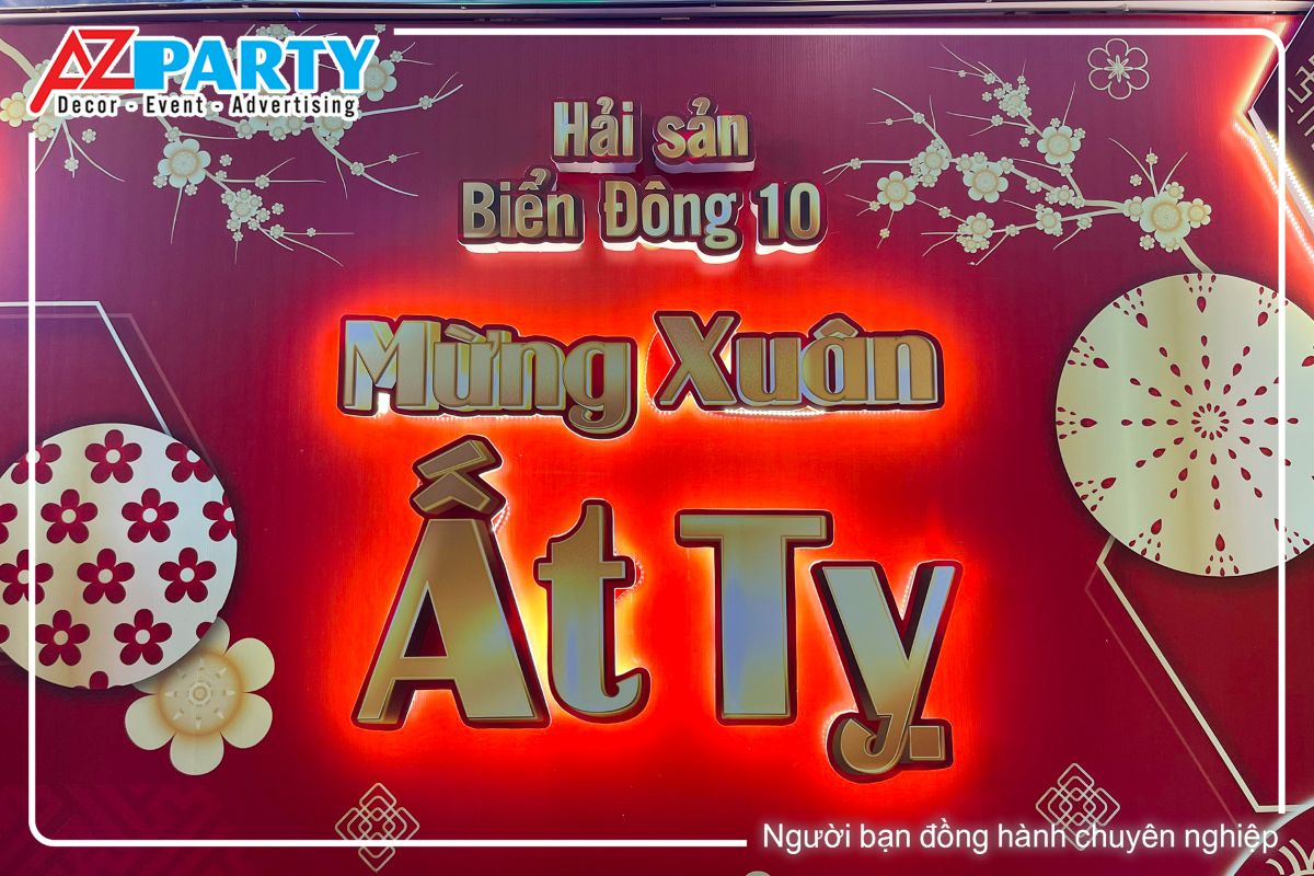 dòng chữ Biển Đông 10 Mừng Xuân Ất Tỵ nổi khối trên backdrop có đèn led vàng bao quanh